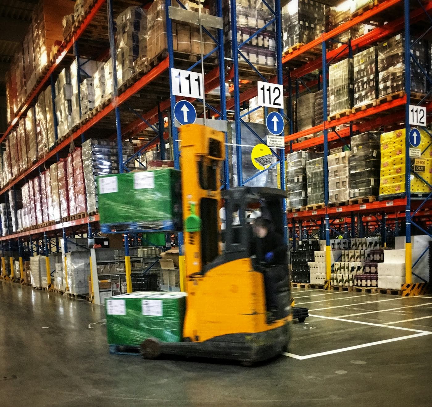 A reach truck working warehouse racking